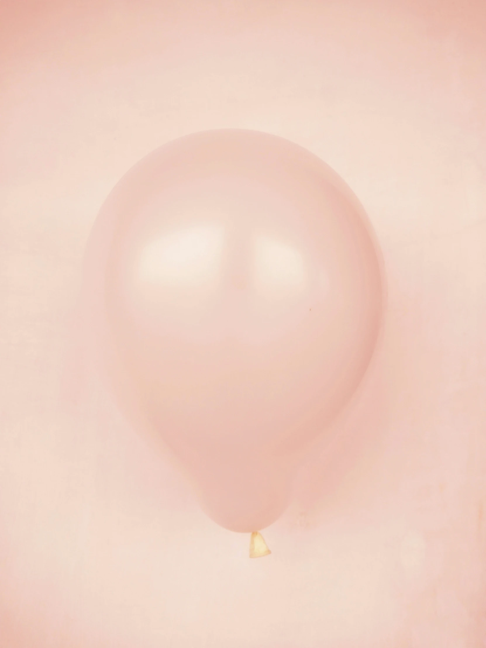 a light colored image of a balloon floating
