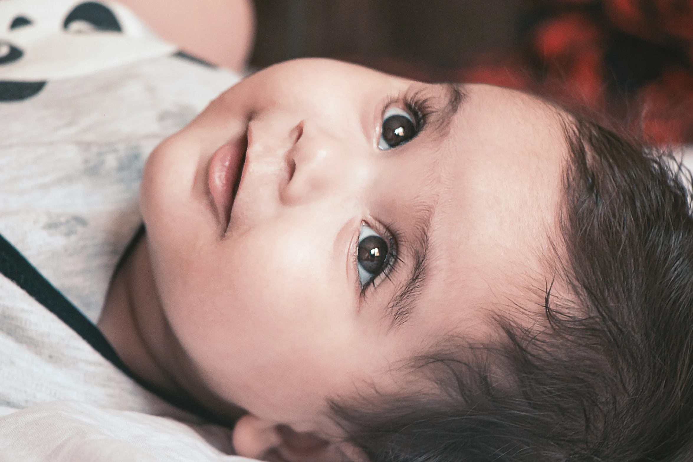 a little child with a big smile looking at the camera