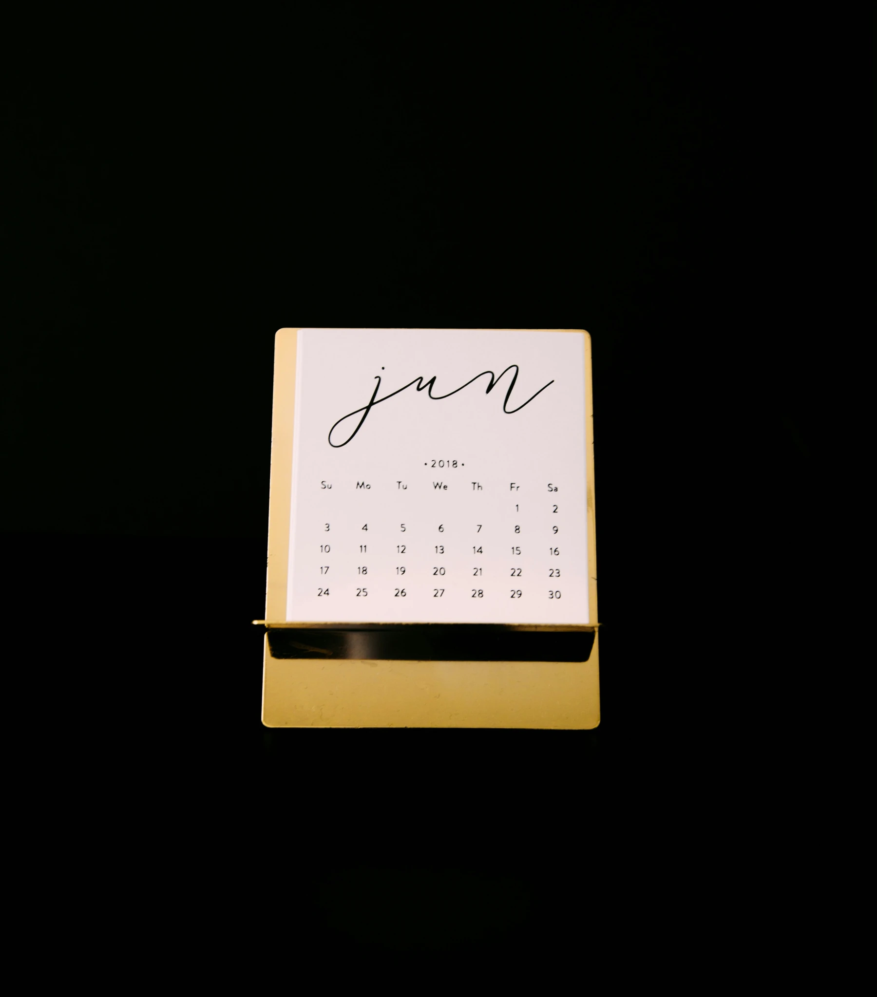 a calendar with a black background, showing the days