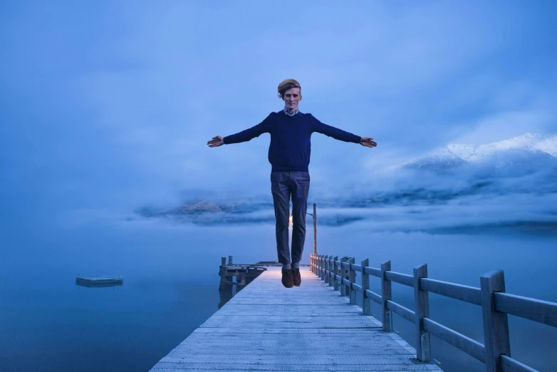 a person standing on a dock by a boat