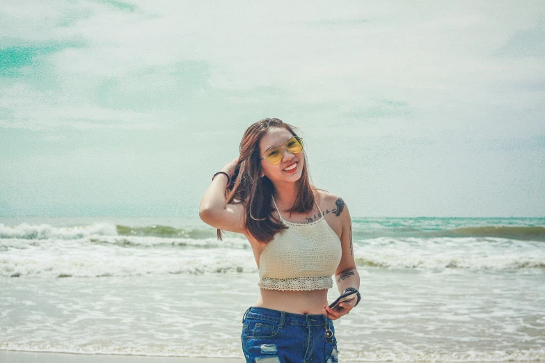 a woman wearing shorts on the beach