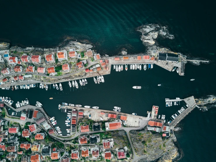 an aerial view of a harbor with sail boats and lots of homes