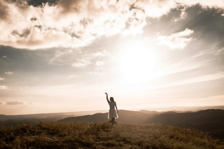 the man is standing on the mountain waving