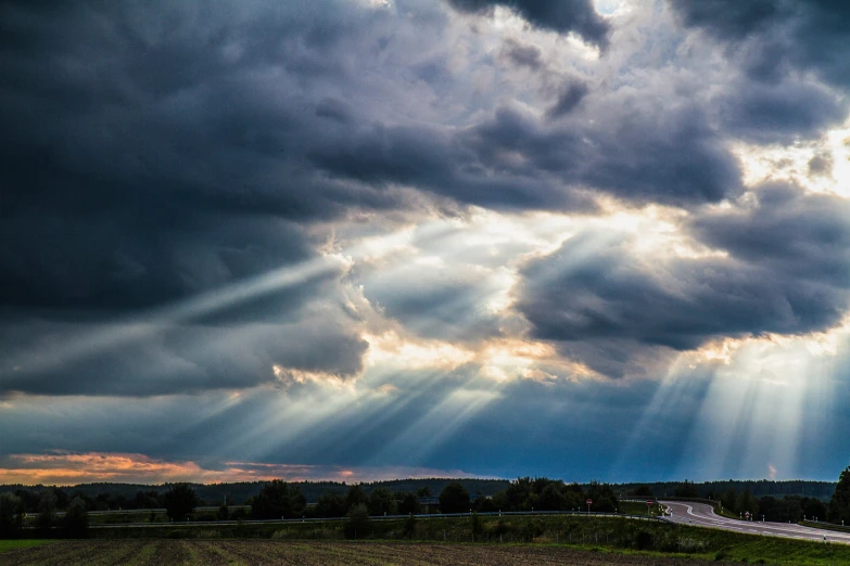 the road on the right has light coming through from a storm