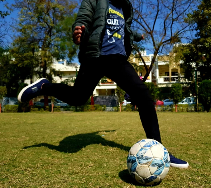 a soccer player runs toward a soccer ball