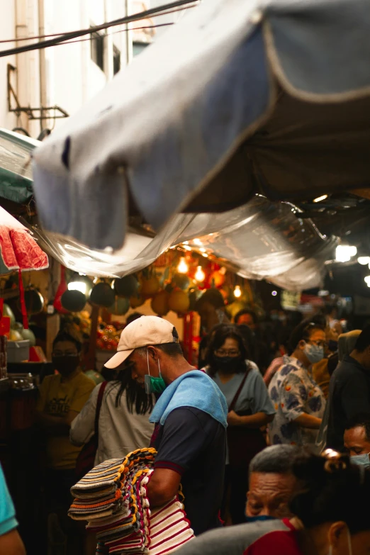 an older man is selling items at a market