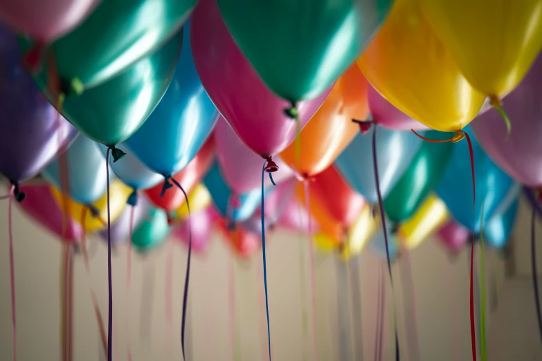 a bunch of balloons are stuck on the wall