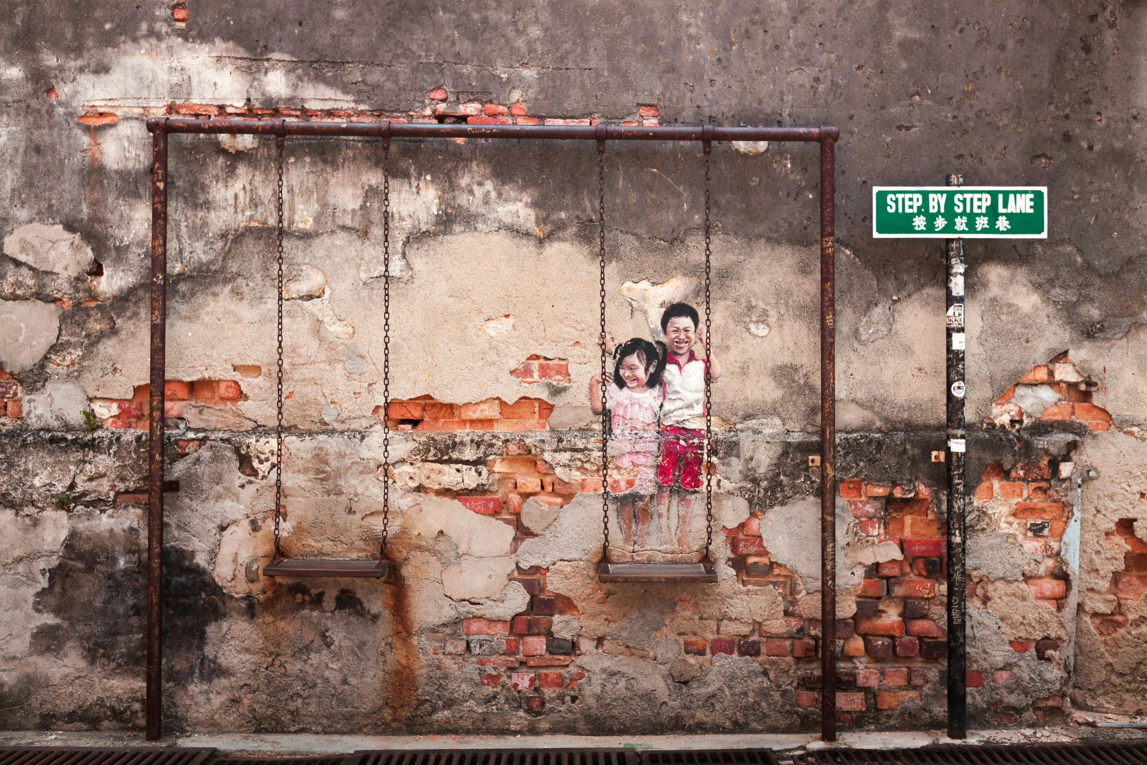 two children are posing for a picture on an old wall