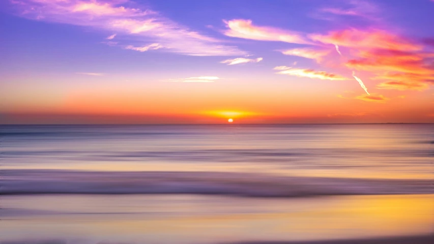 sunset with bright colors over ocean waves and ocean water