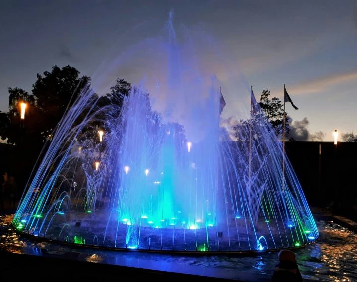 a bright light display of lights near a pond at night