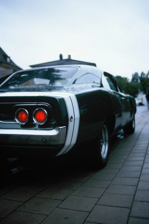 a black muscle car parked on the street