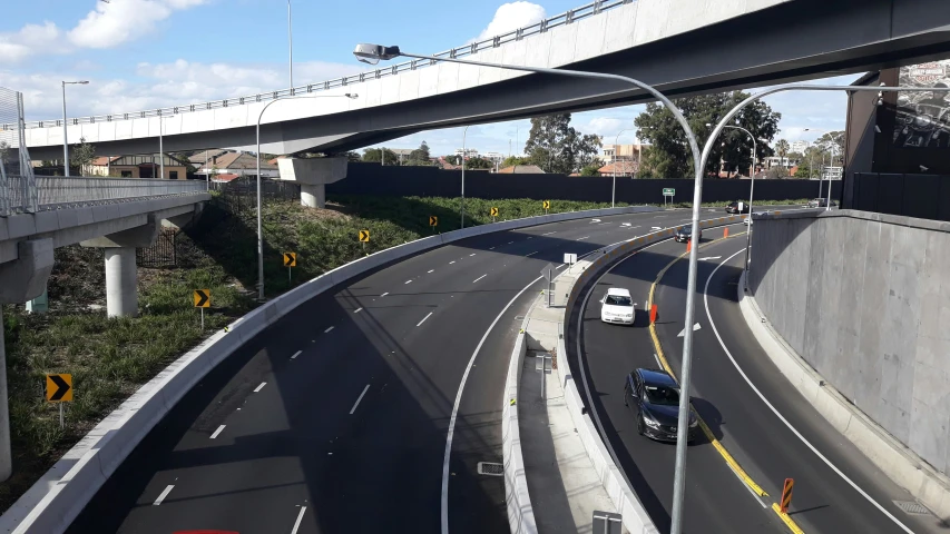 an overhead view of a highway with bridge and vehicles