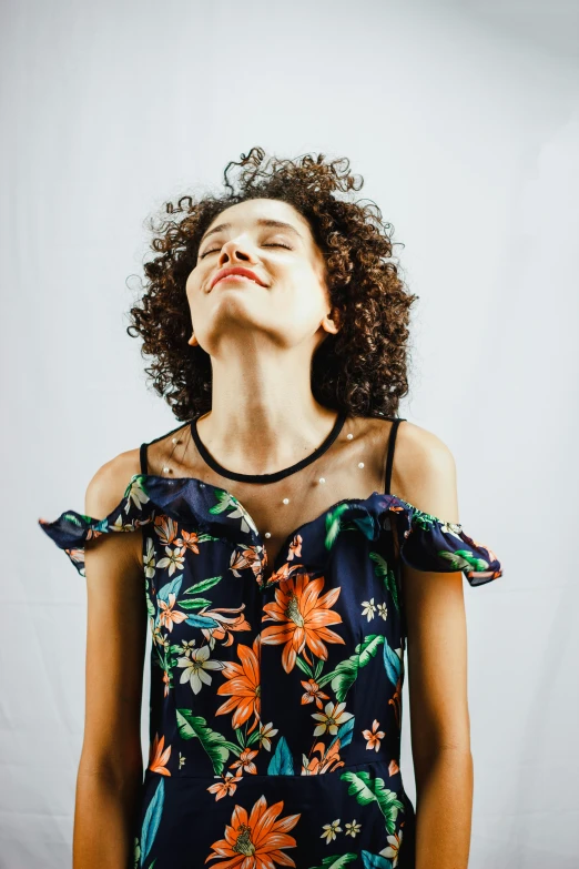 a woman looks up in the air with her eyes closed