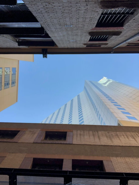 a high rise building seen looking up from the ground