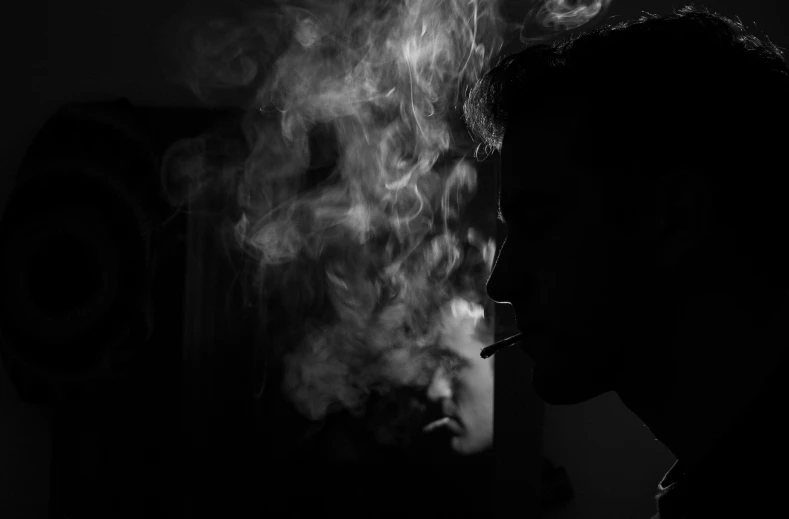 a black - and - white image of smoke coming out of a cigarette lighter