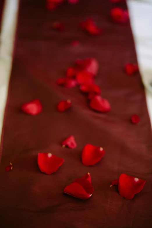 a red cloth with rose petals on the floor