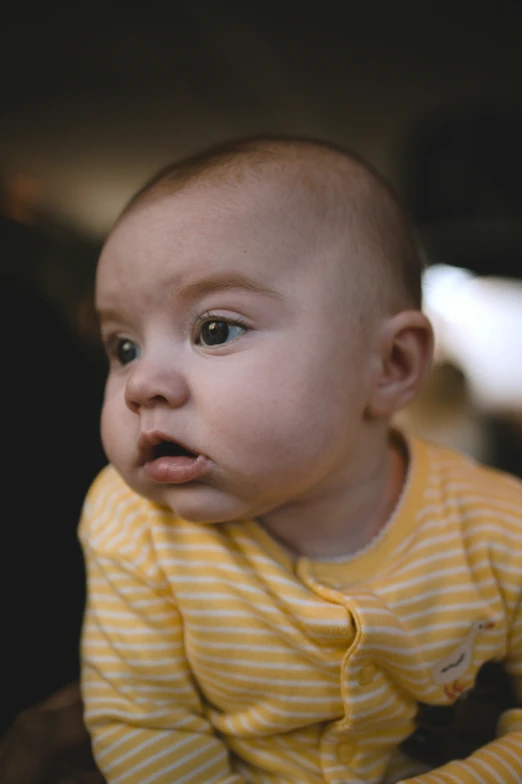 a baby girl with a surprised look on her face