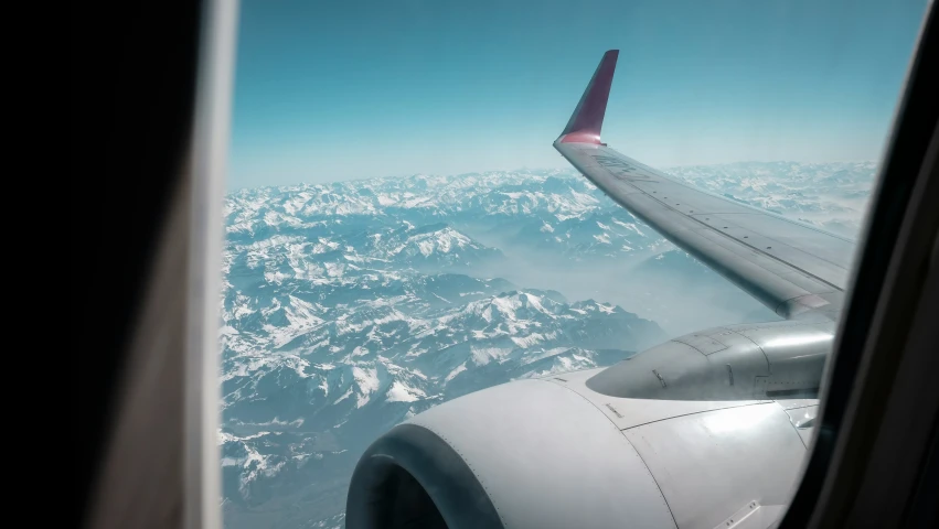 view out an airplane window showing the wing in motion