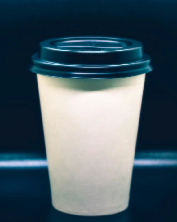 a coffee cup with a black lid is shown