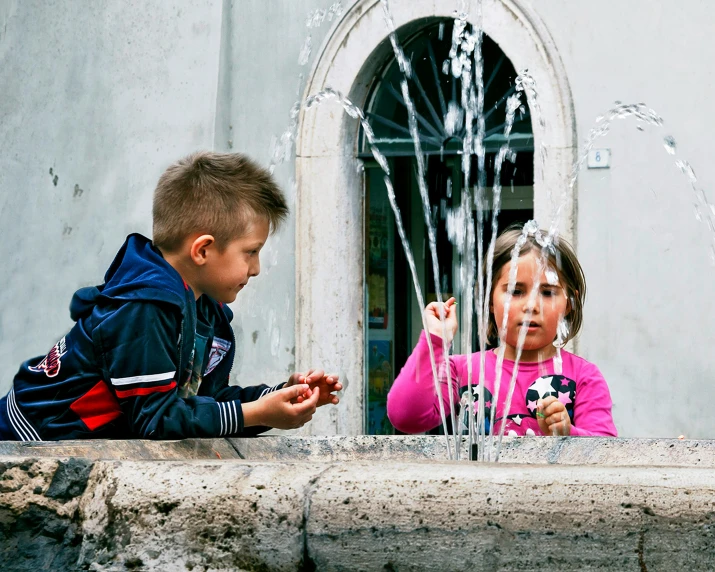 two children looking out the window at each other