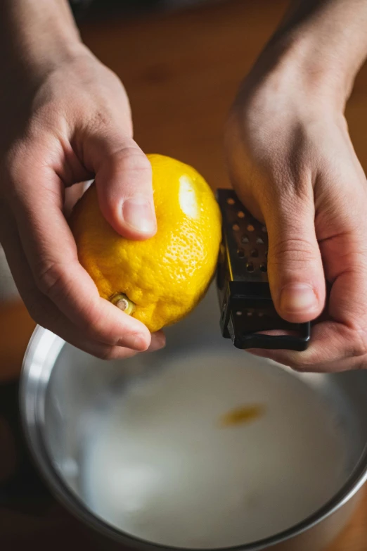 a person holds an orange and prepares to peel it