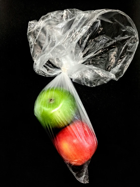 there is an apple inside of a plastic bag