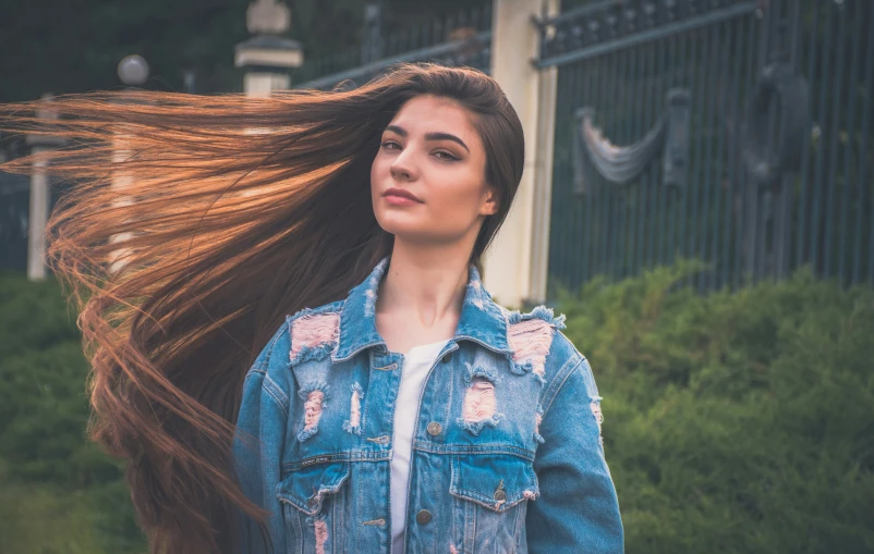 a woman with long hair and jacket on