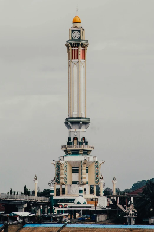 a tall white and gold tower with a clock