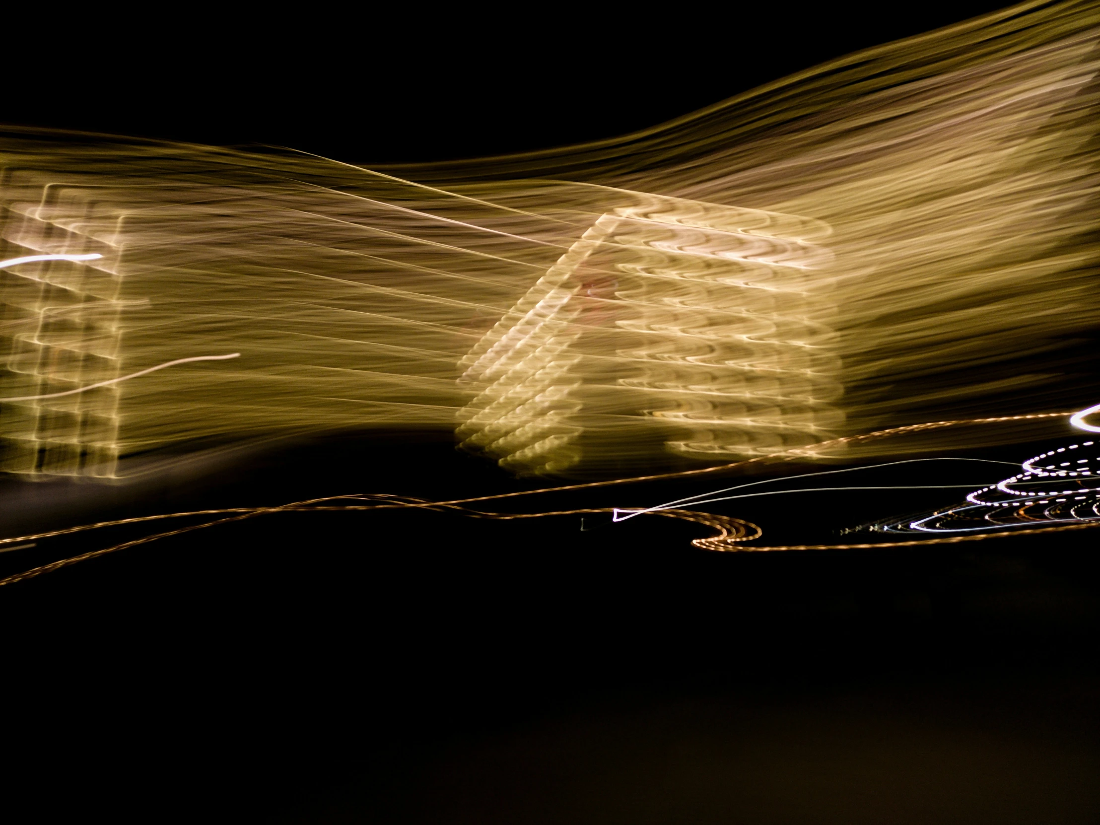 a person holding a skateboard at night