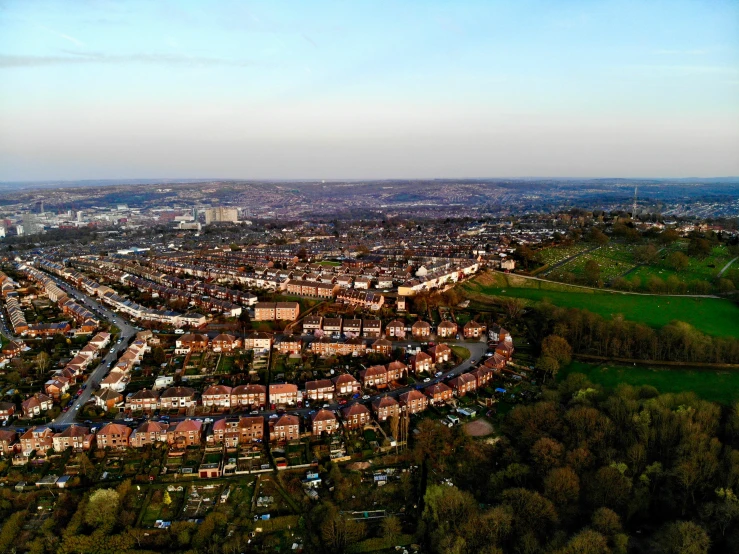 an aerial po of a city with trees on both sides of it