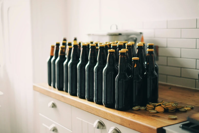 a counter with many black bottles on it