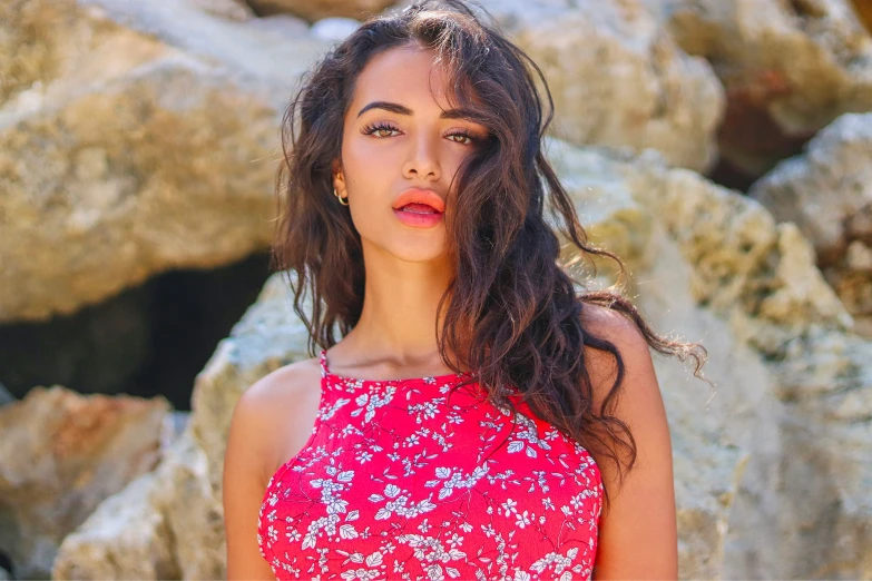 a girl wearing a red dress posing for a picture