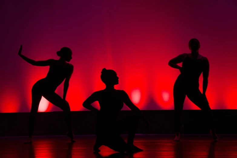 several dance ballet silhouettes dancing on the floor