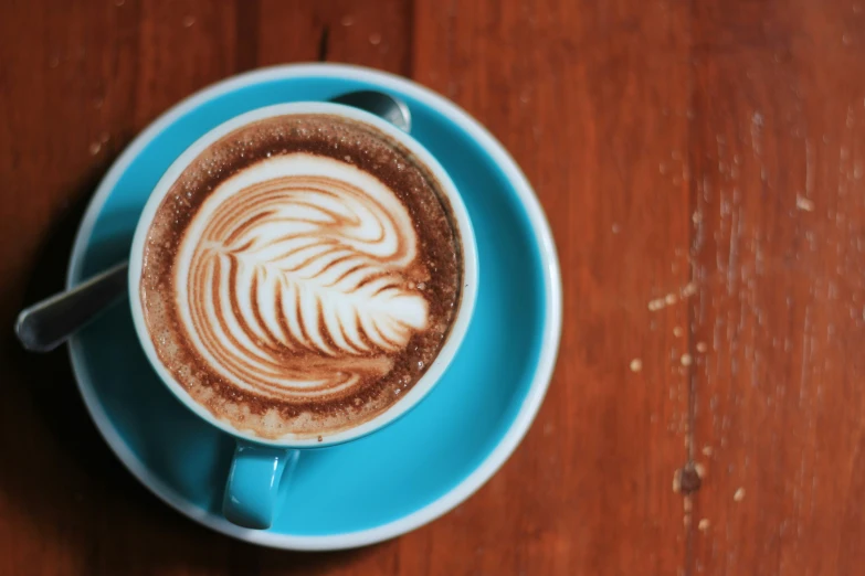 a cup of coffee on a saucer on a table