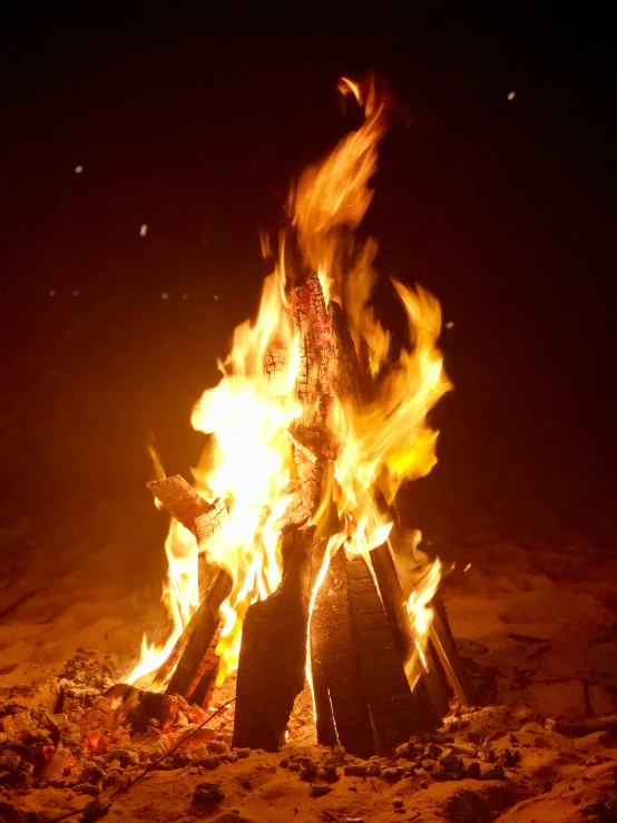 a blazing fire is seen during a dark night