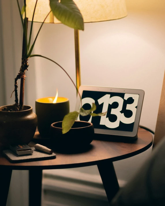 a table with two small pots and a laptop