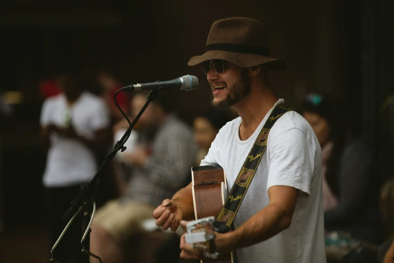 a man playing music with an acoustic guitar