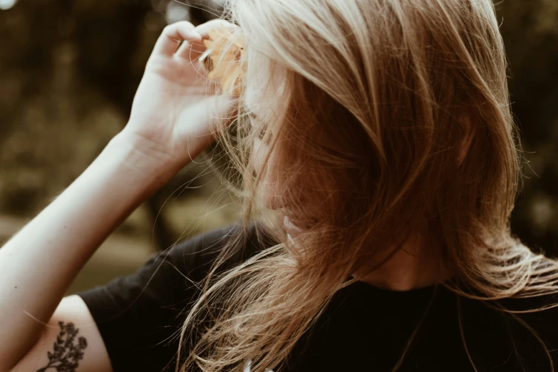 a woman with a small tattoo holds up food