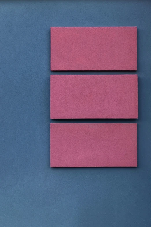 a single piece of pink paper sitting on top of a blue surface