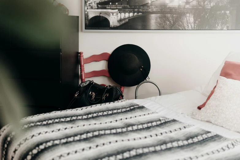 a hat and a purse are shown on a small bed