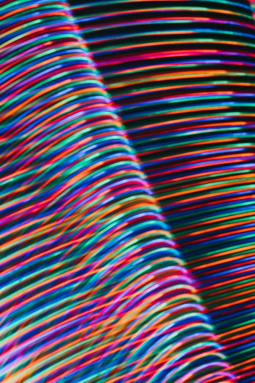 colorful lines and shapes are seen in a dark room