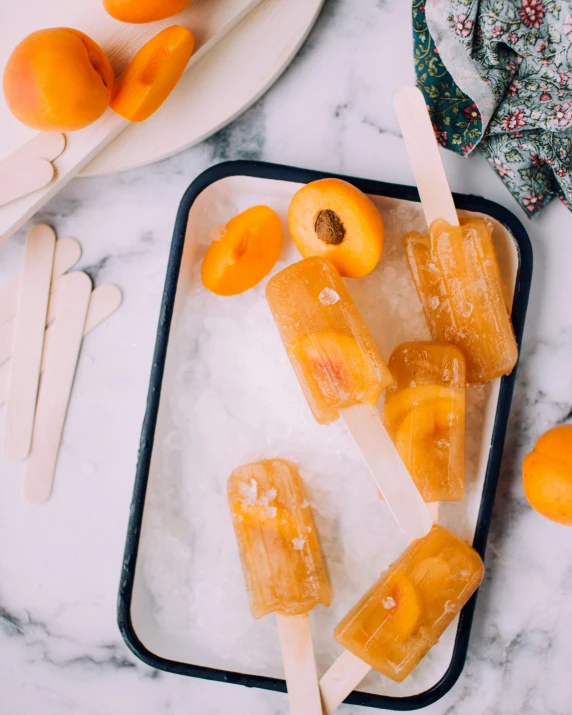 a tray filled with pops on top of ice