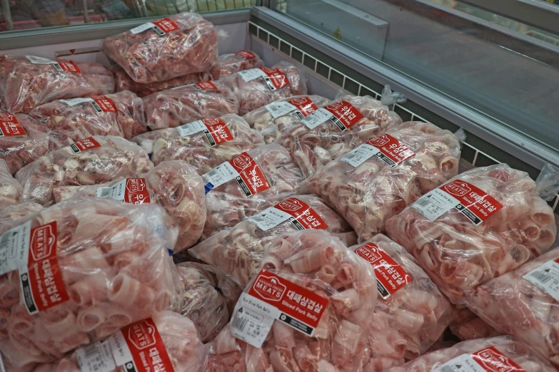 a display in a grocery store full of sliced and uncooked meat