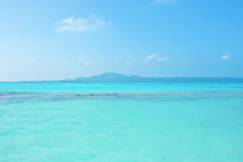 two people riding in a paddle boat on the clear waters of blue lagoons