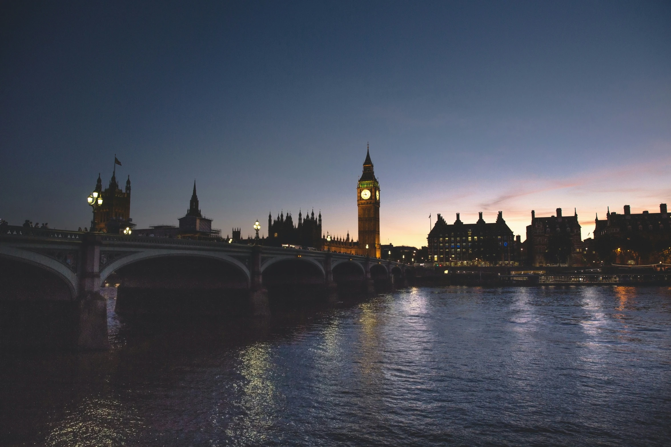 a clock tower at sunset with the other side of it