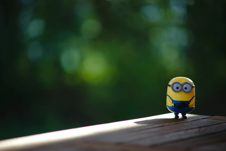 a small toy sits atop of a wood table