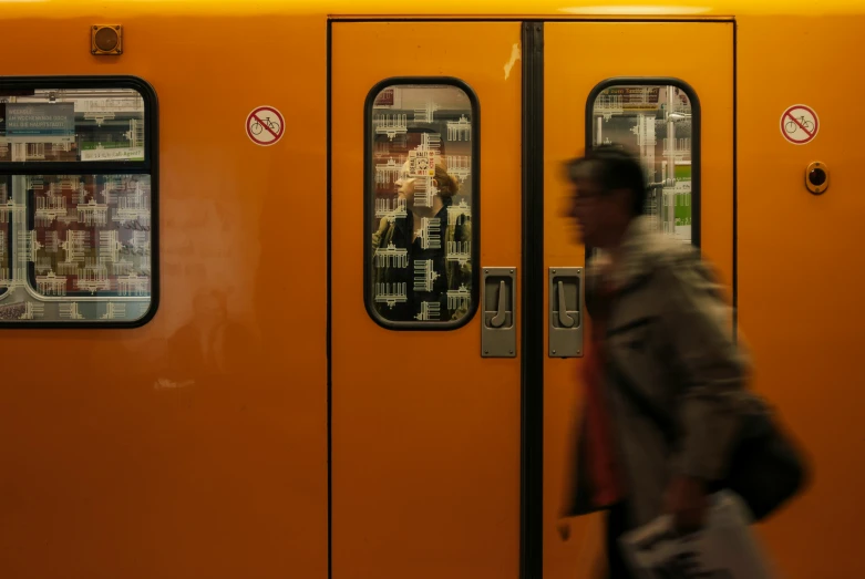 the side door of a train with an employee approaching