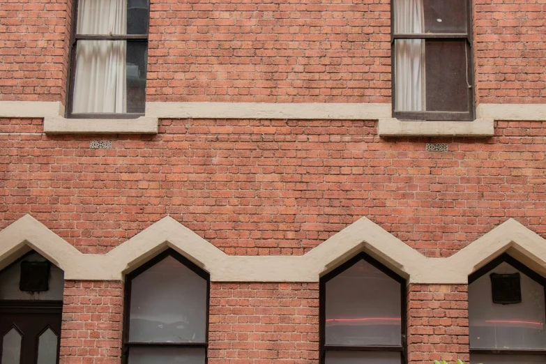 a clock on the side of a brick building