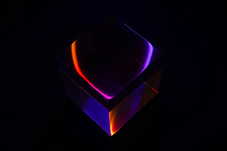a modern sculpture with bright light in a dark room
