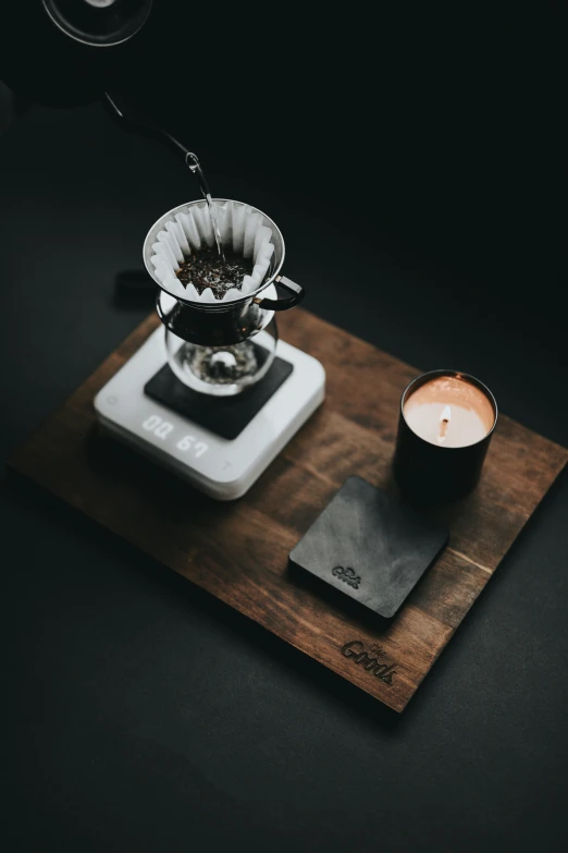 a candle and some tea in front of it